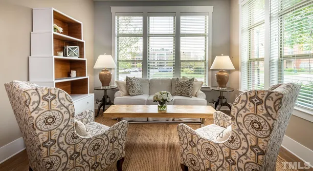 a living room with furniture and wooden floor