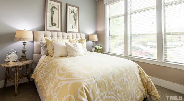 a very nice looking room with a large window and furniture