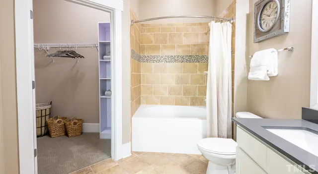 a kitchen with stainless steel appliances a table and chairs in it