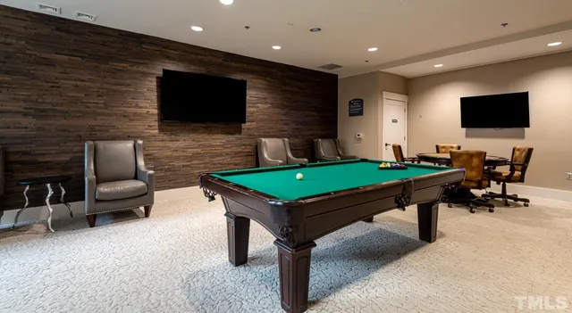 a living room with pool table and a flat screen tv