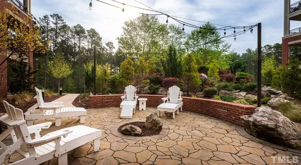 a view of a patio with couple of chairs and a fire pit