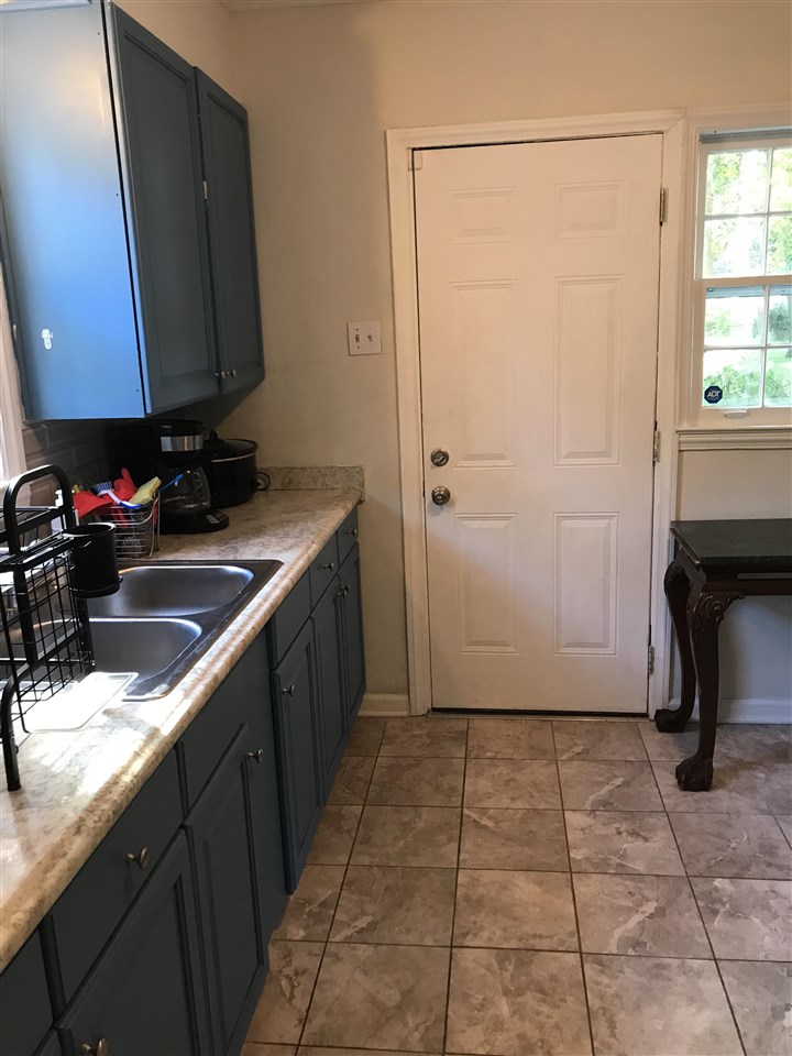 1193 Wright Road Memphis, TN 38122 - Photo 22 of 25 a kitchen with a sink a counter and a cabinets