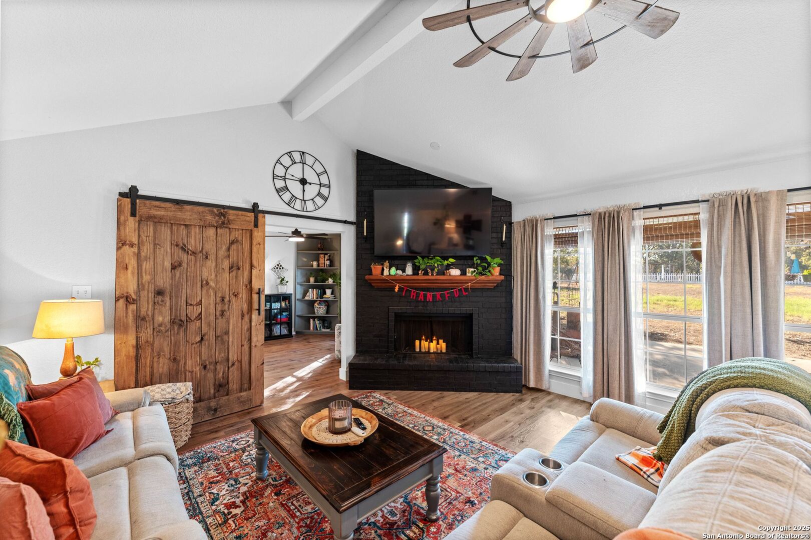 1265 Hillside Oaks Drive La Vernia, TX 78121 - Photo 12 of 72 a living room with furniture a flat screen tv and a fireplace