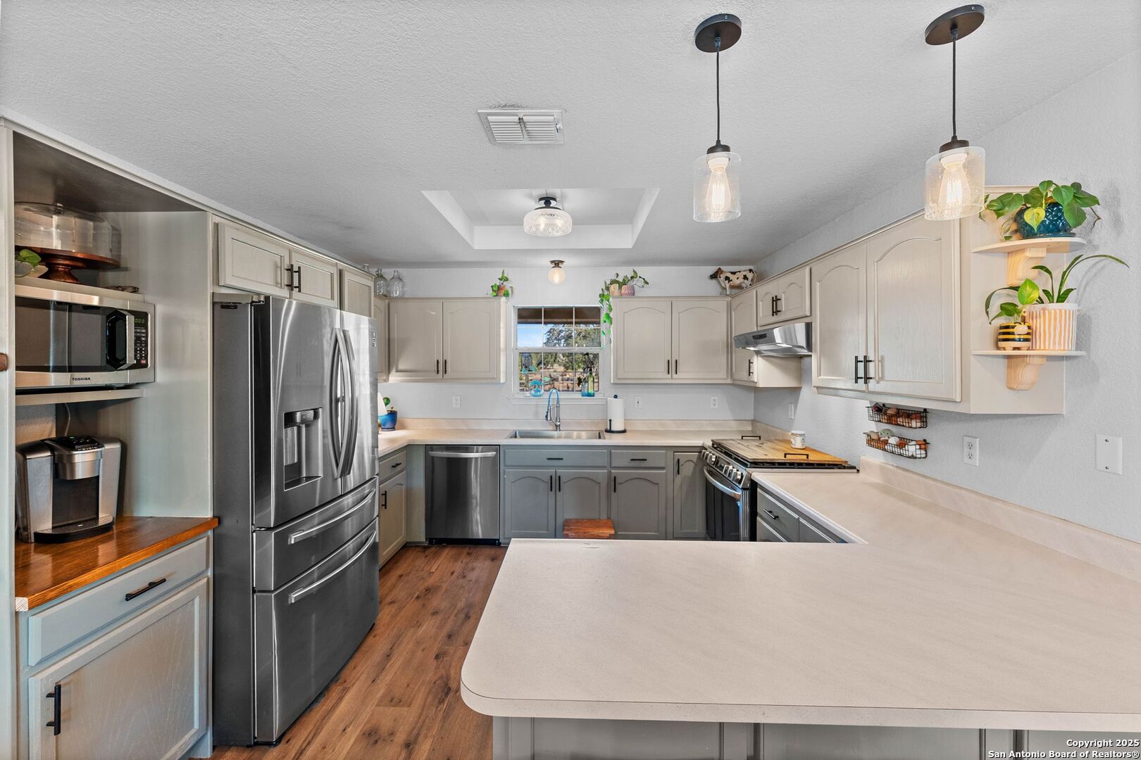 1265 Hillside Oaks Drive La Vernia, TX 78121 - Photo 13 of 72 a kitchen with stainless steel appliances granite countertop a refrigerator a oven a stove and a sink