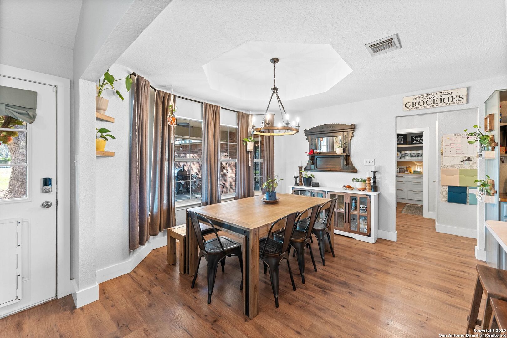 1265 Hillside Oaks Drive La Vernia, TX 78121 - Photo 16 of 72 a view of a dining room with furniture window and wooden floor