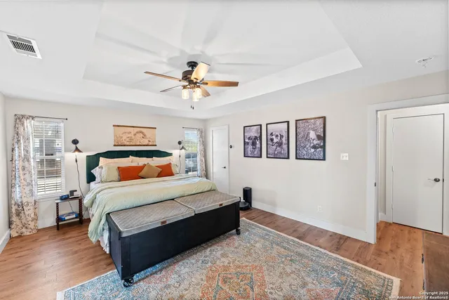 a bedroom with a bed and wooden floor