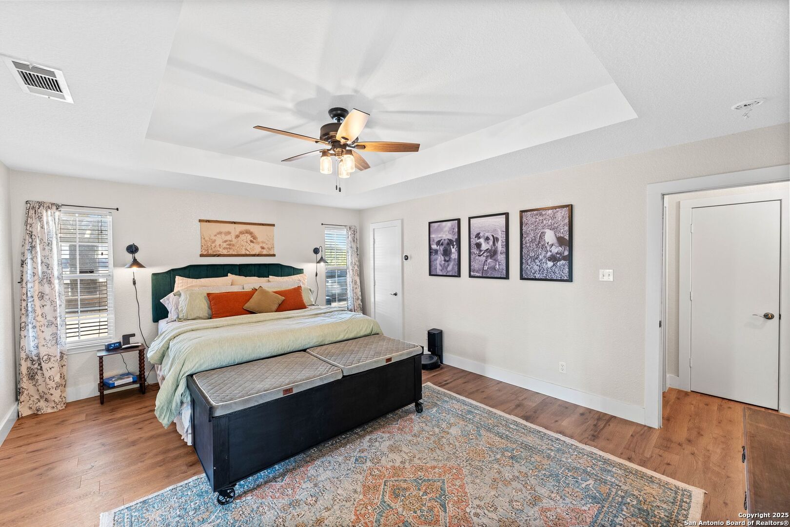 1265 Hillside Oaks Drive La Vernia, TX 78121 - Photo 19 of 72 a bedroom with a large bed and a chandelier