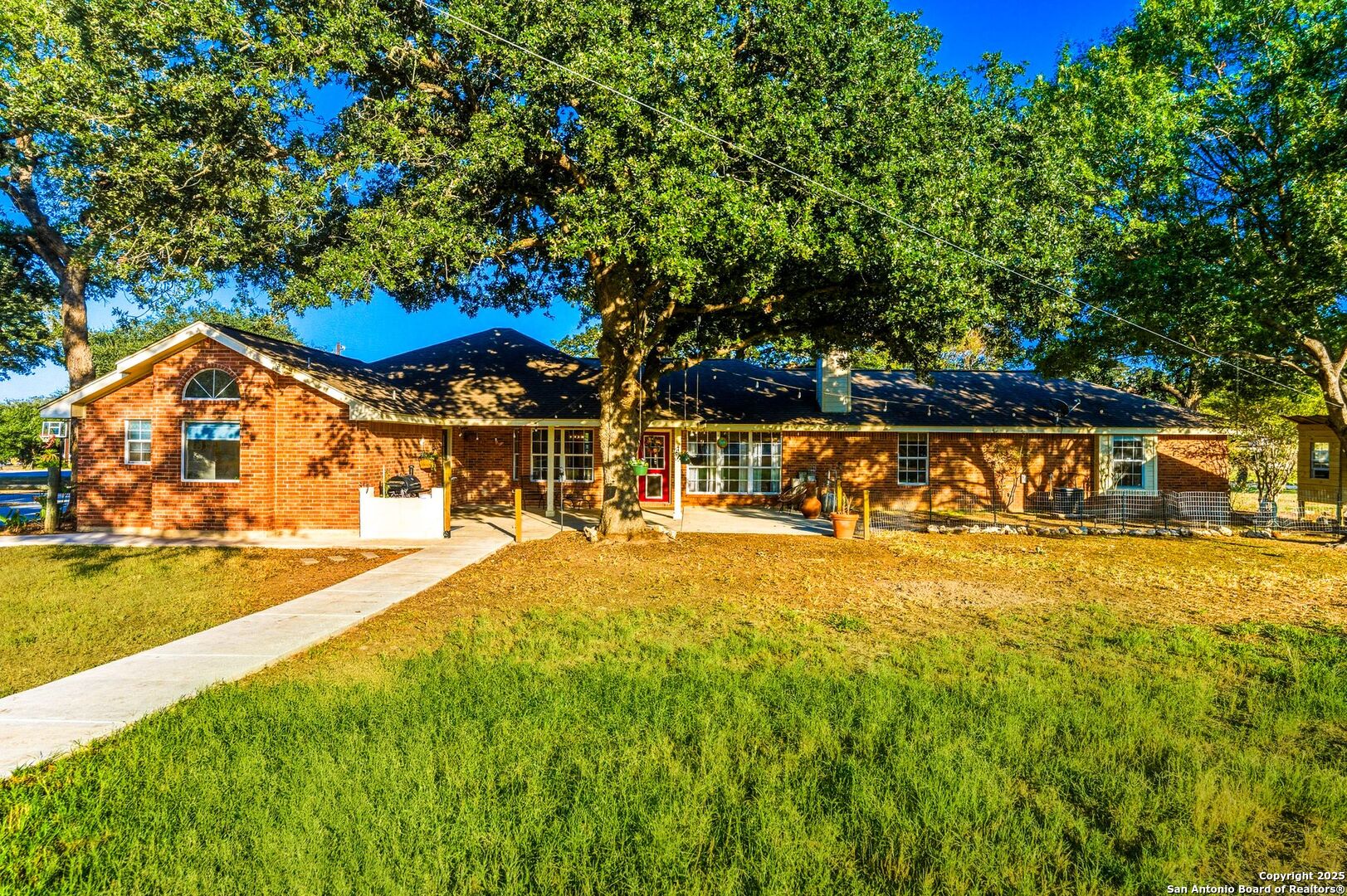 1265 Hillside Oaks Drive La Vernia, TX 78121 - Photo 3 of 72 a view of swimming pool with lawn chairs under an umbrella