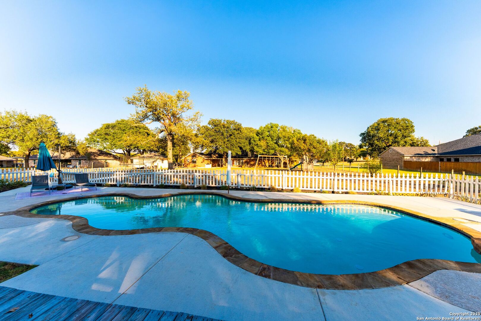 1265 Hillside Oaks Drive La Vernia, TX 78121 - Photo 47 of 72 a view of a swimming pool with an outdoor space and seating area