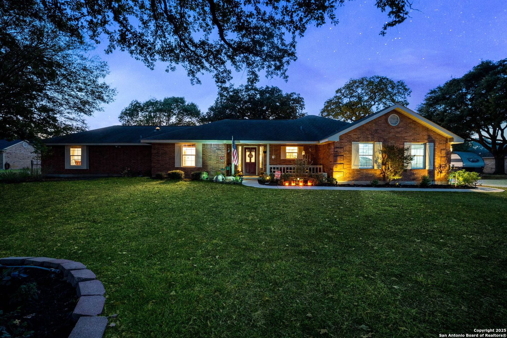 1265 Hillside Oaks Drive La Vernia, TX 78121 - Photo 59 of 72 a front view of a house with a garden and yard