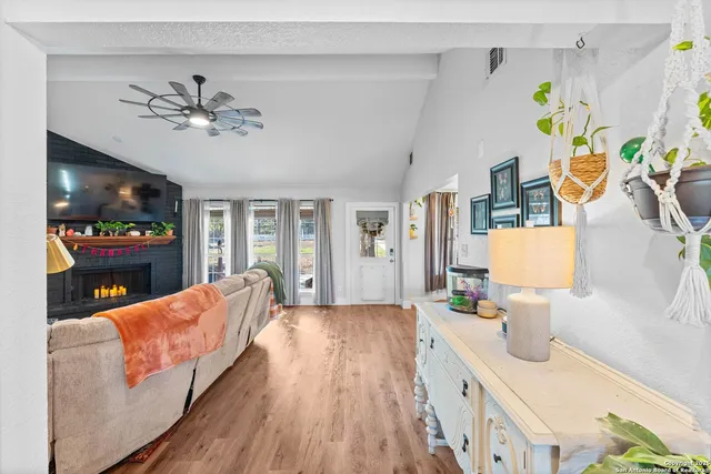 a living room with furniture and wooden floor