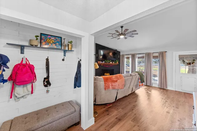 a living room with furniture a fireplace and a flat screen tv