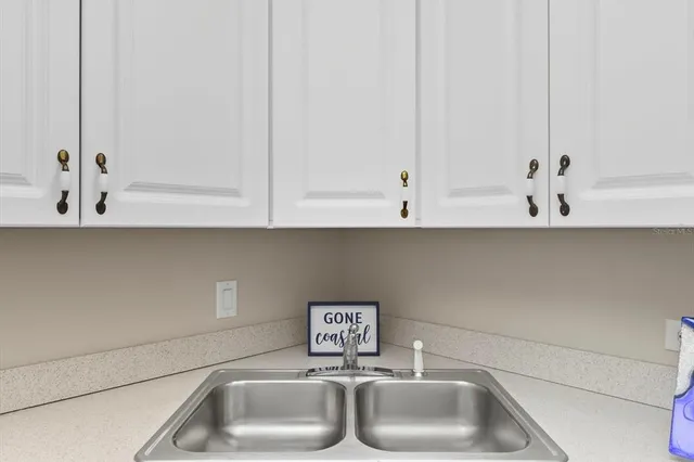 a bathroom with a sink and cabinets