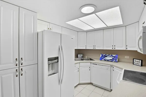 a kitchen with stainless steel appliances a refrigerator sink and cabinets