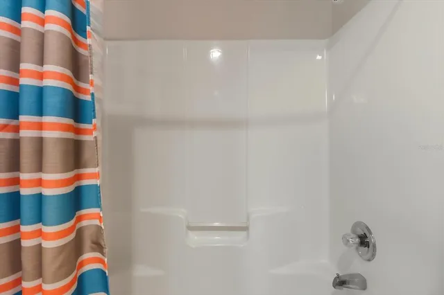 a bathroom with a sink and a shower curtain