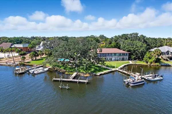 a view of a swimming pool with lawn chairs in front of it