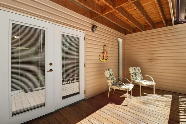 a balcony with wooden floor and furniture