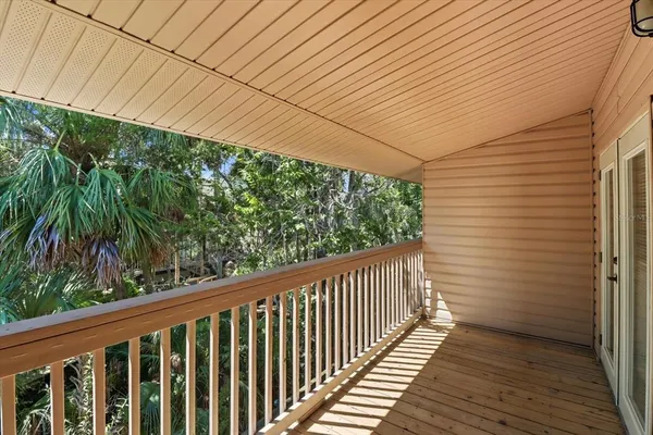a view of a balcony with wooden floor