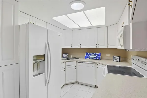 a kitchen with cabinets and white appliances
