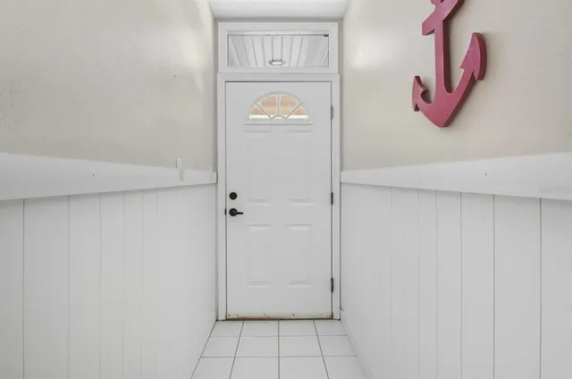 a view of an entryway with wooden floor