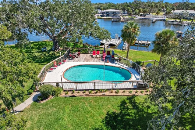 an aerial view of a house with a garden and swimming pool
