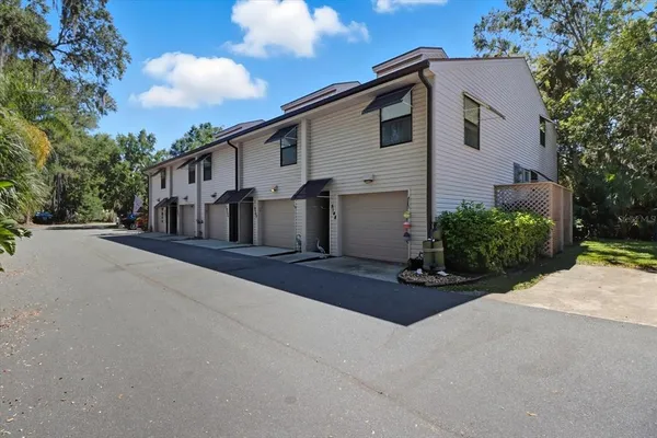 a view of a white house with a street