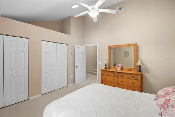 a room with a bed and a dresser