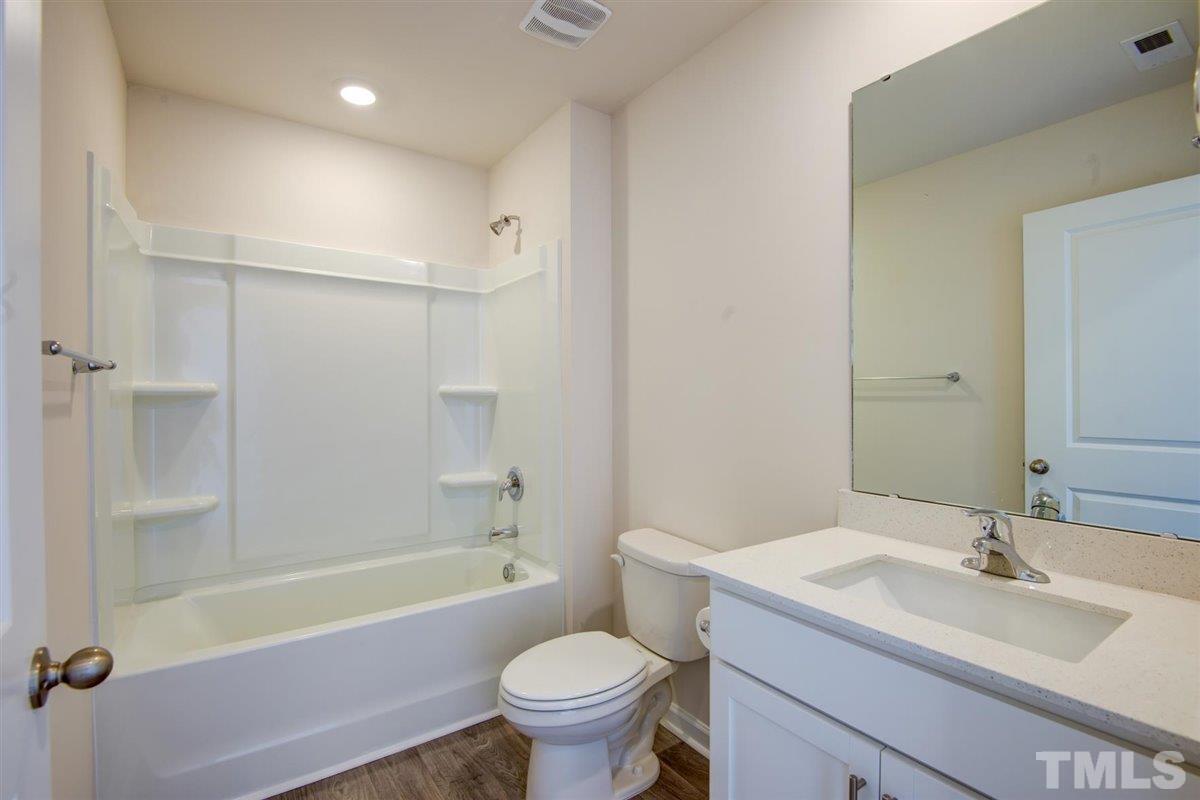 7653 Sand Pit Road Stantonsburg, NC 27883 - Photo 5 of 28 a bathroom with a sink toilet tub vanity and shower
