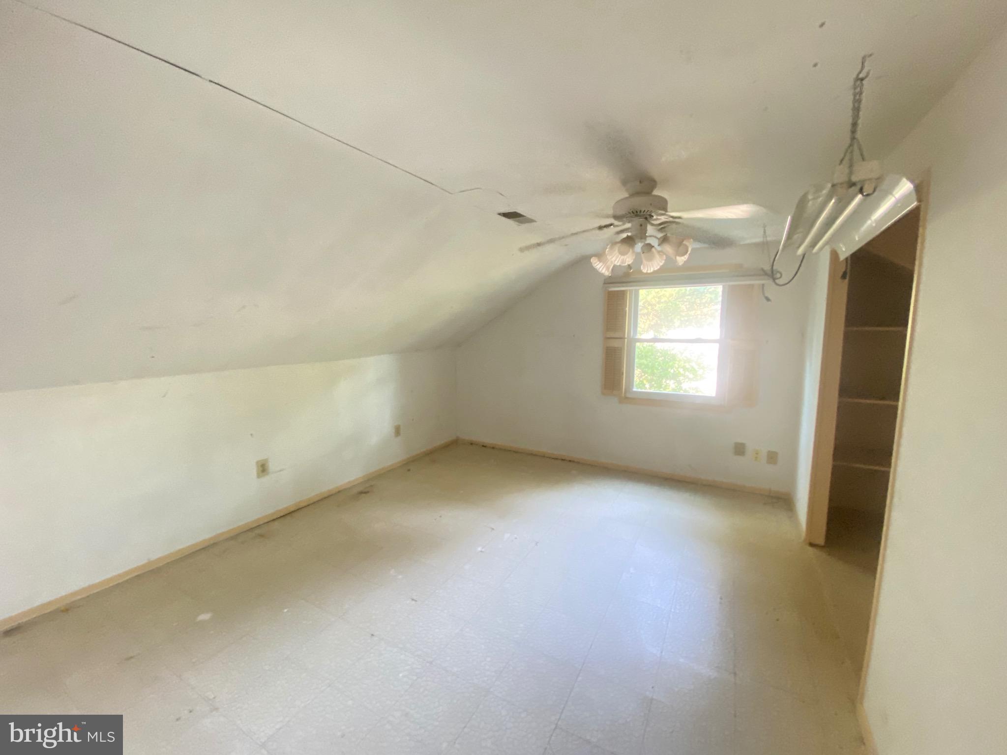 2703 Lyn Place Bowie, MD 20715 - Photo 13 of 14 an empty room with a chandelier fan and windows