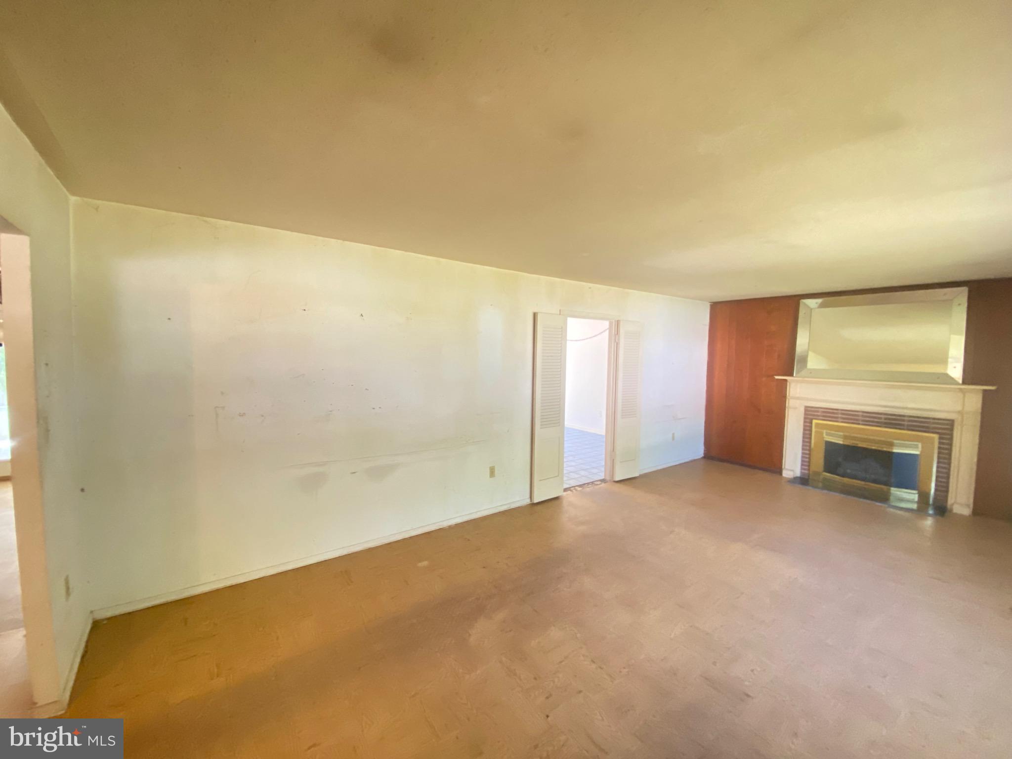 2703 Lyn Place Bowie, MD 20715 - Photo 5 of 14 a view of an empty room with a fireplace