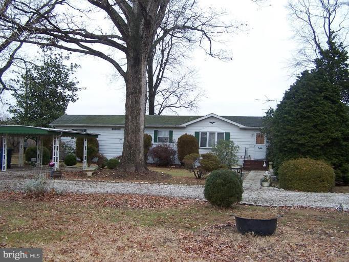 a front view of a house with a yard and outdoor seating