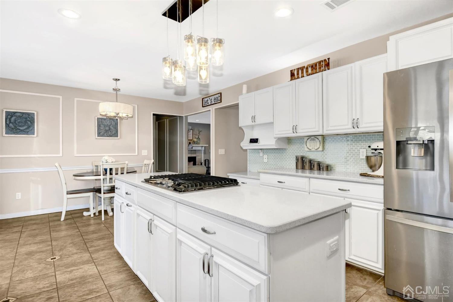 365 Cedar Swamp Road Jackson, NJ 08527 - Photo 11 of 38 a kitchen with a stove a sink a refrigerator and cabinets