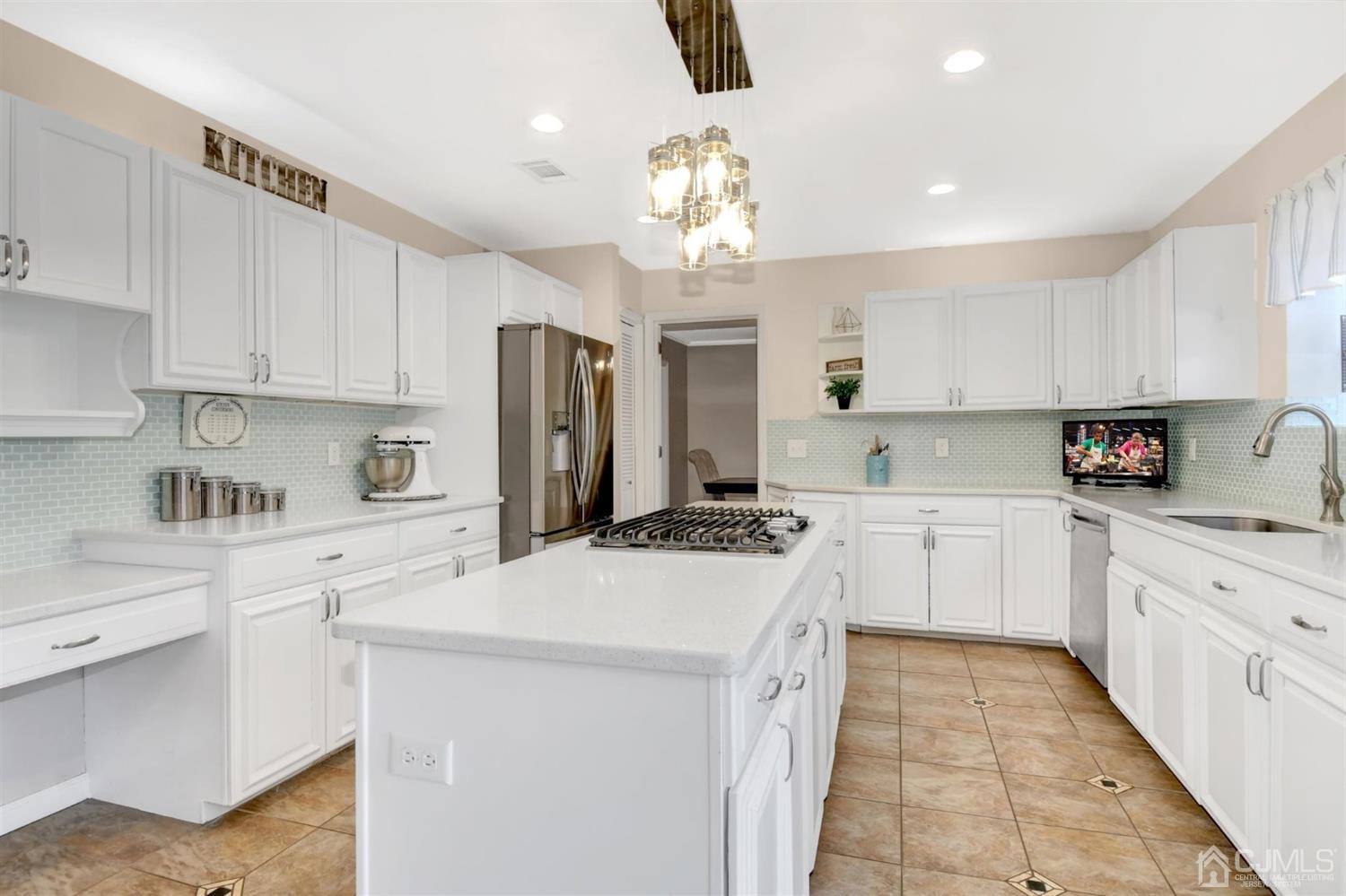 365 Cedar Swamp Road Jackson, NJ 08527 - Photo 12 of 38 a kitchen with a sink a stove a refrigerator and white cabinets