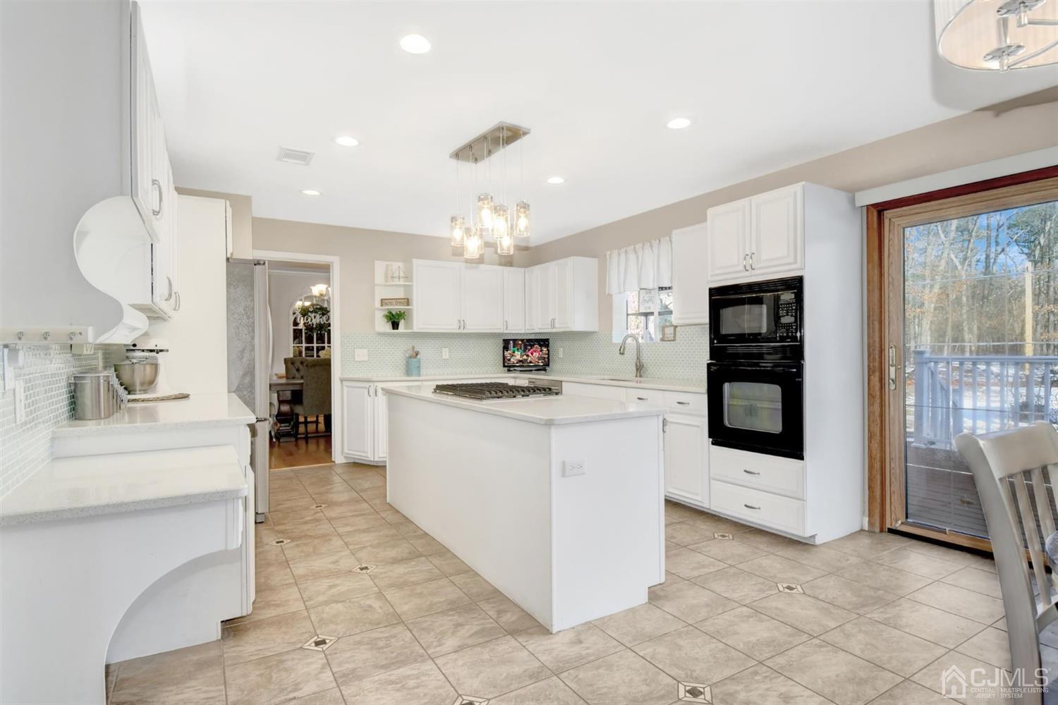365 Cedar Swamp Road Jackson, NJ 08527 - Photo 13 of 38 a kitchen with stainless steel appliances kitchen island granite countertop a refrigerator and a stove top oven