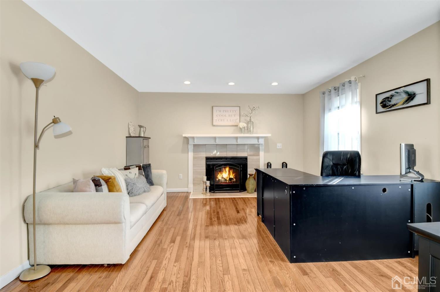 365 Cedar Swamp Road Jackson, NJ 08527 - Photo 15 of 38 a living room with furniture and a fireplace