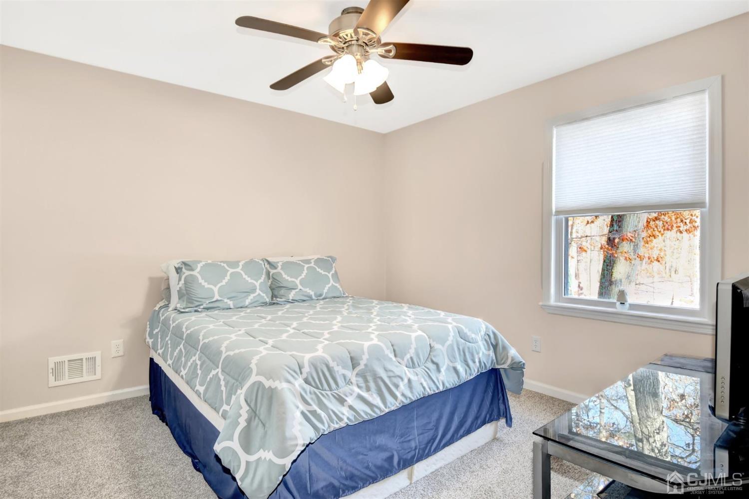 365 Cedar Swamp Road Jackson, NJ 08527 - Photo 24 of 38 a bedroom with a bed and window