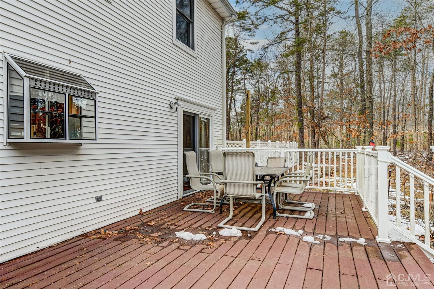 365 Cedar Swamp Road Jackson, NJ 08527 - Photo 29 of 38 a view of a roof deck with table and chairs and wooden floor