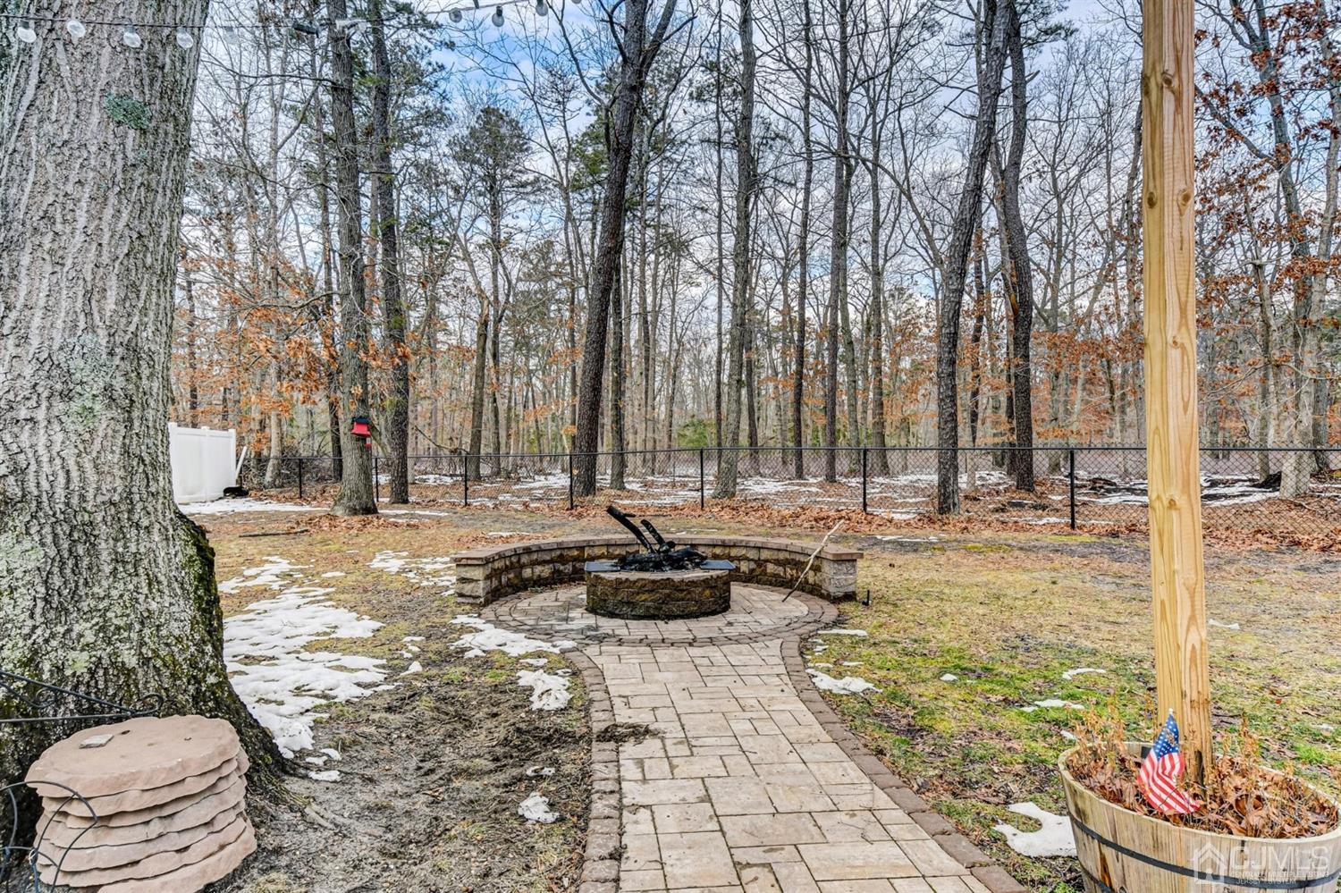 365 Cedar Swamp Road Jackson, NJ 08527 - Photo 31 of 38 a view of a backyard with table and chairs and couches with wooden fence and plants