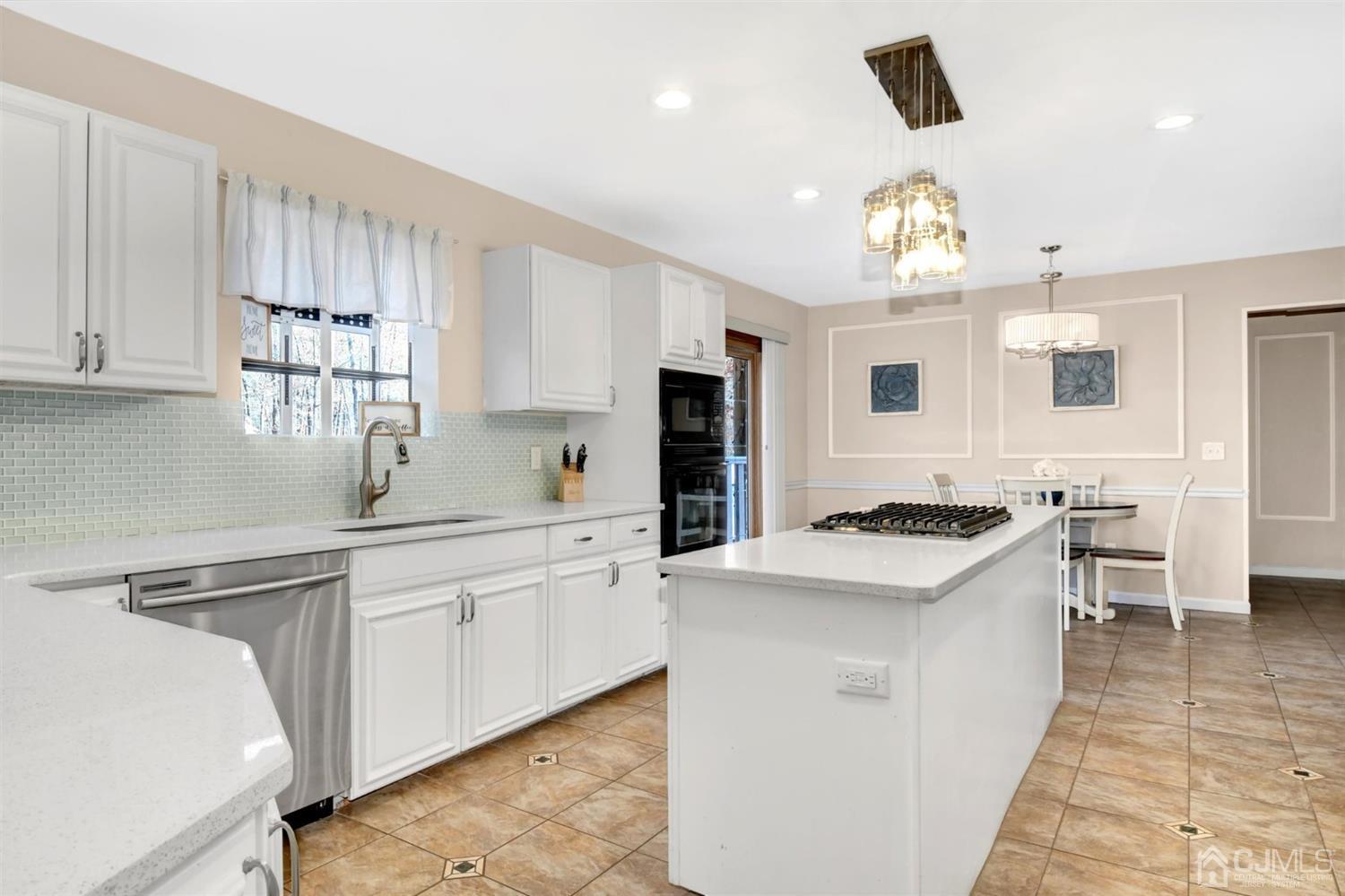 365 Cedar Swamp Road Jackson, NJ 08527 - Photo 10 of 38 a kitchen with granite countertop a sink a stove refrigerator and cabinets