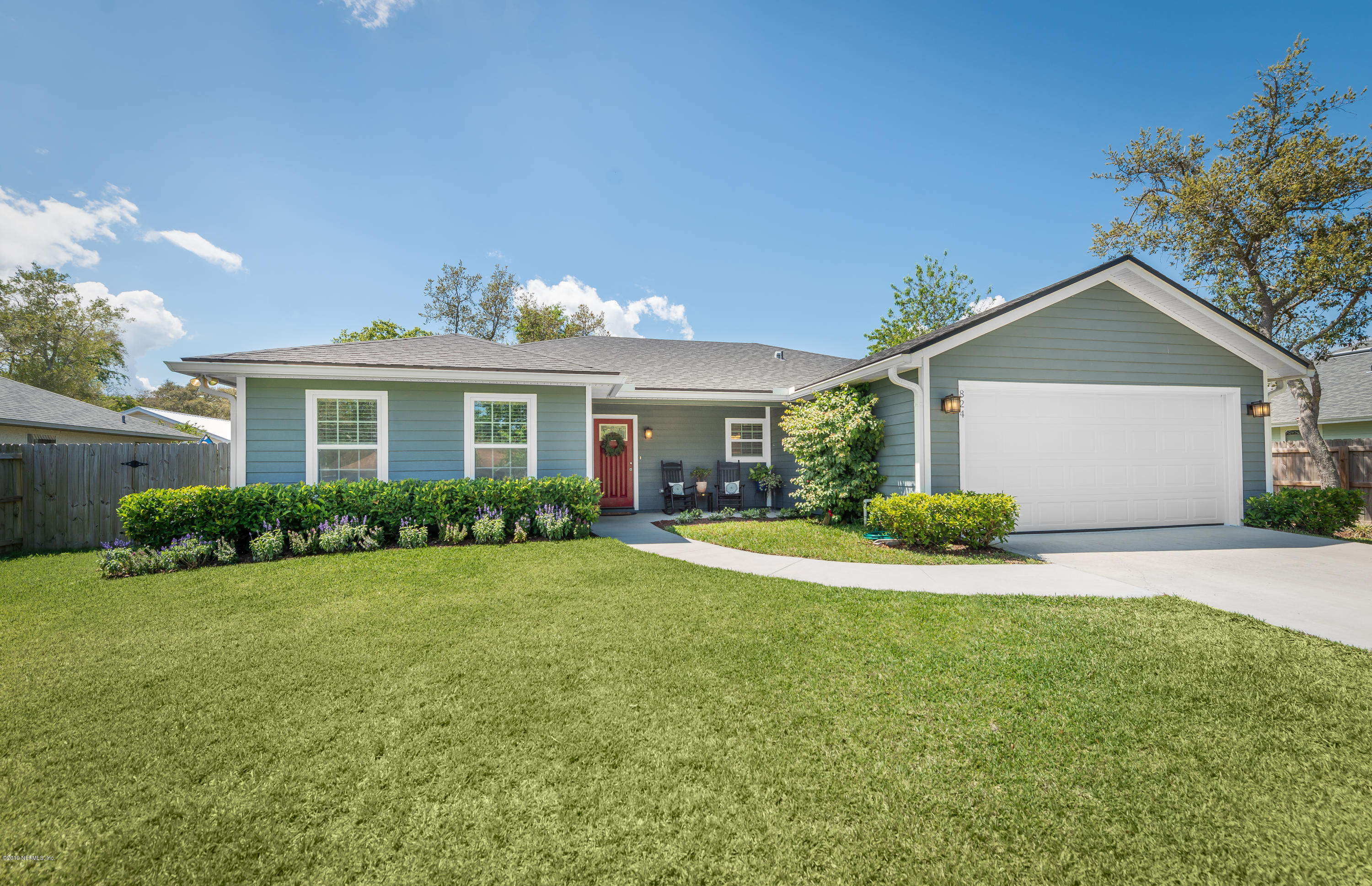 824 Queen Road St. Augustine, FL 32086 - Photo 1 of 35 a front view of a house with a yard and garage