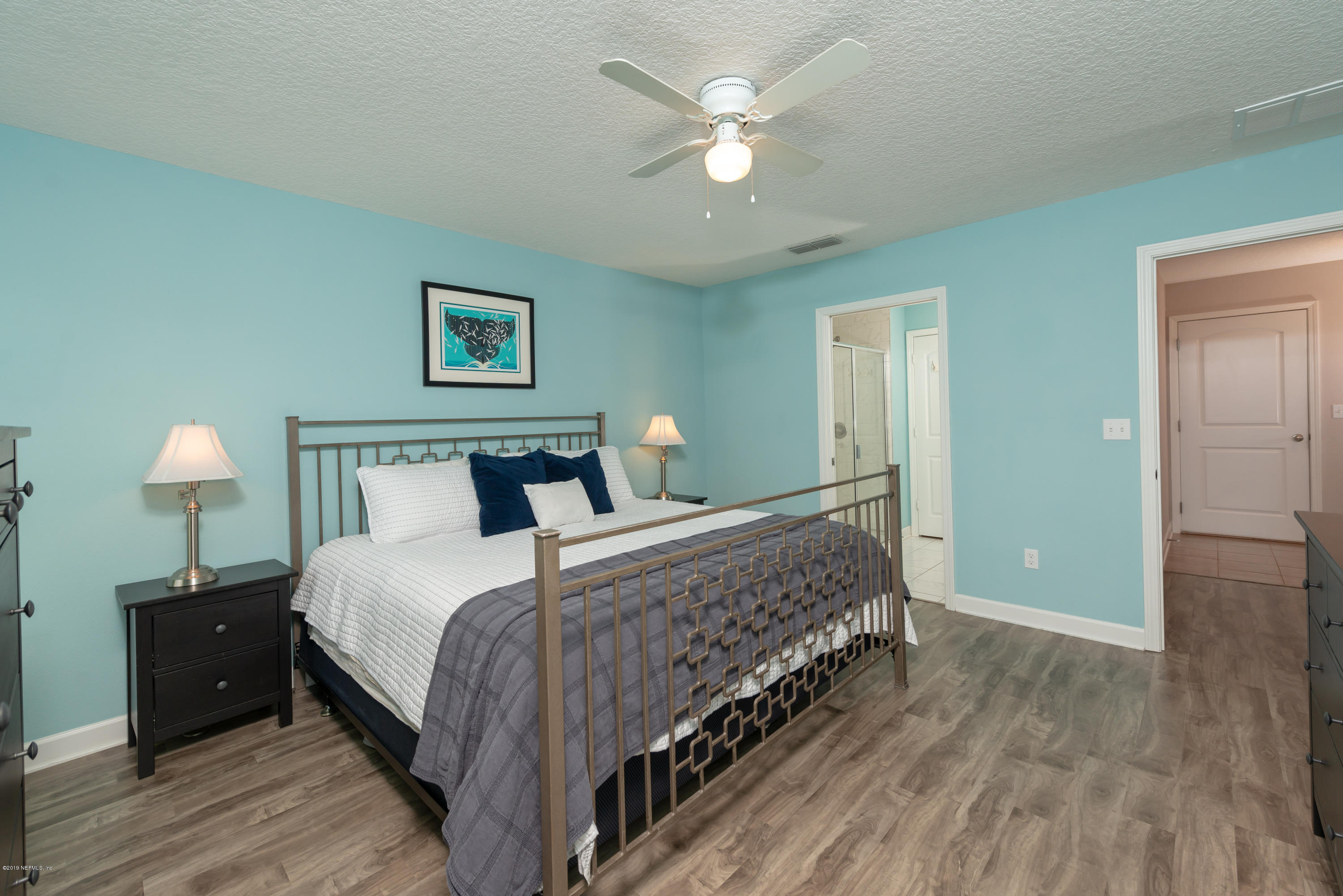 824 Queen Road St. Augustine, FL 32086 - Photo 16 of 35 a bedroom with bed and a chandelier