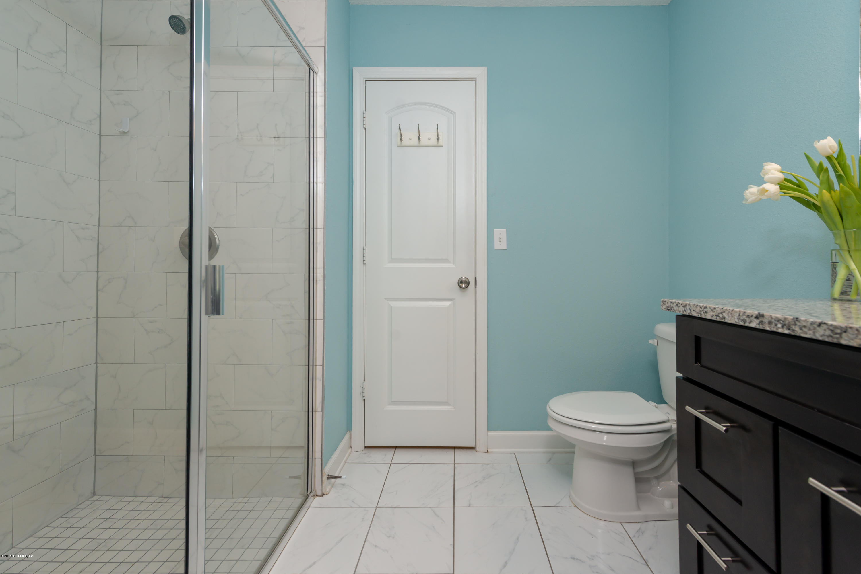 824 Queen Road St. Augustine, FL 32086 - Photo 18 of 35 a bathroom with a granite countertop toilet and a shower