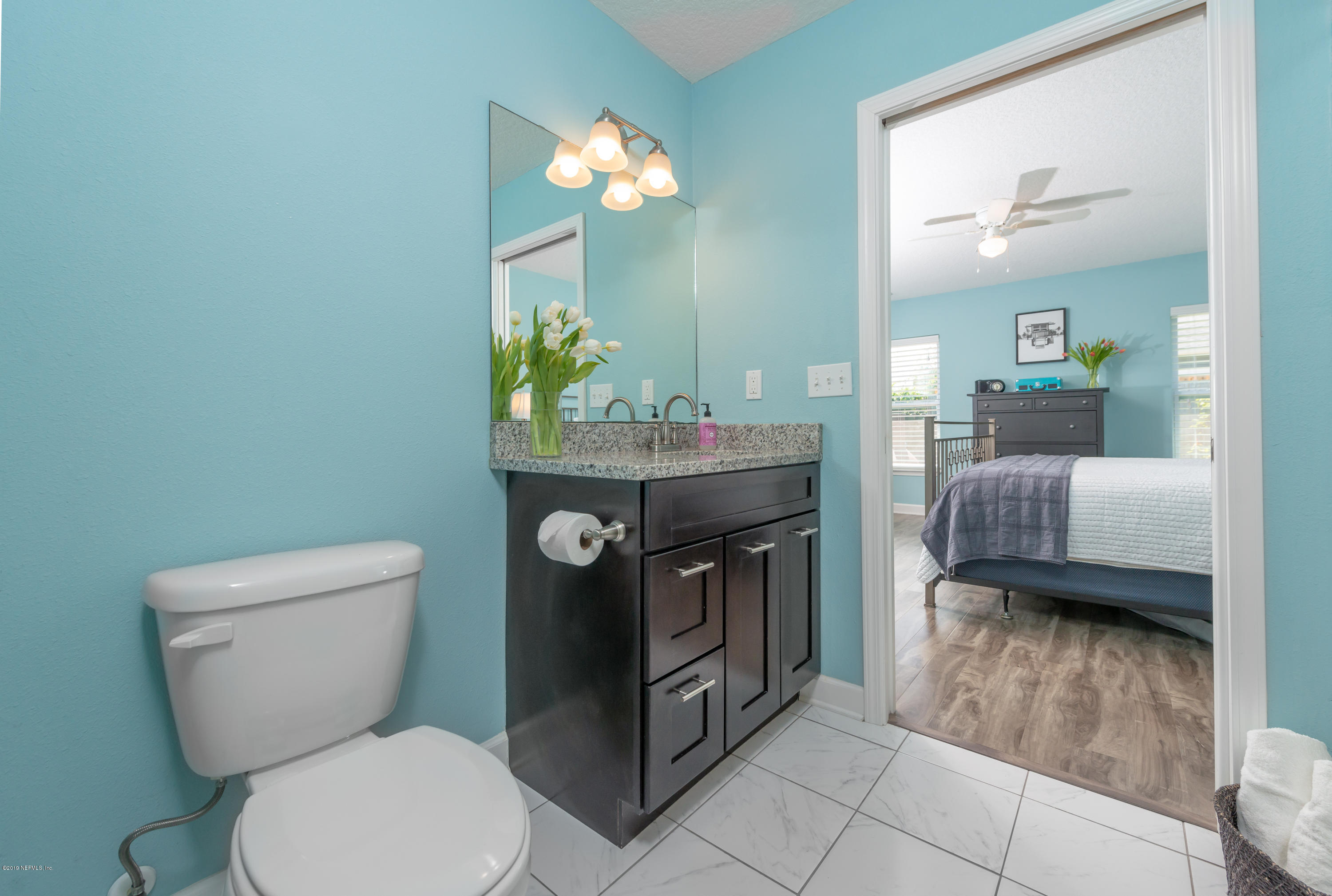 824 Queen Road St. Augustine, FL 32086 - Photo 21 of 35 a bathroom with a toilet a sink and mirror