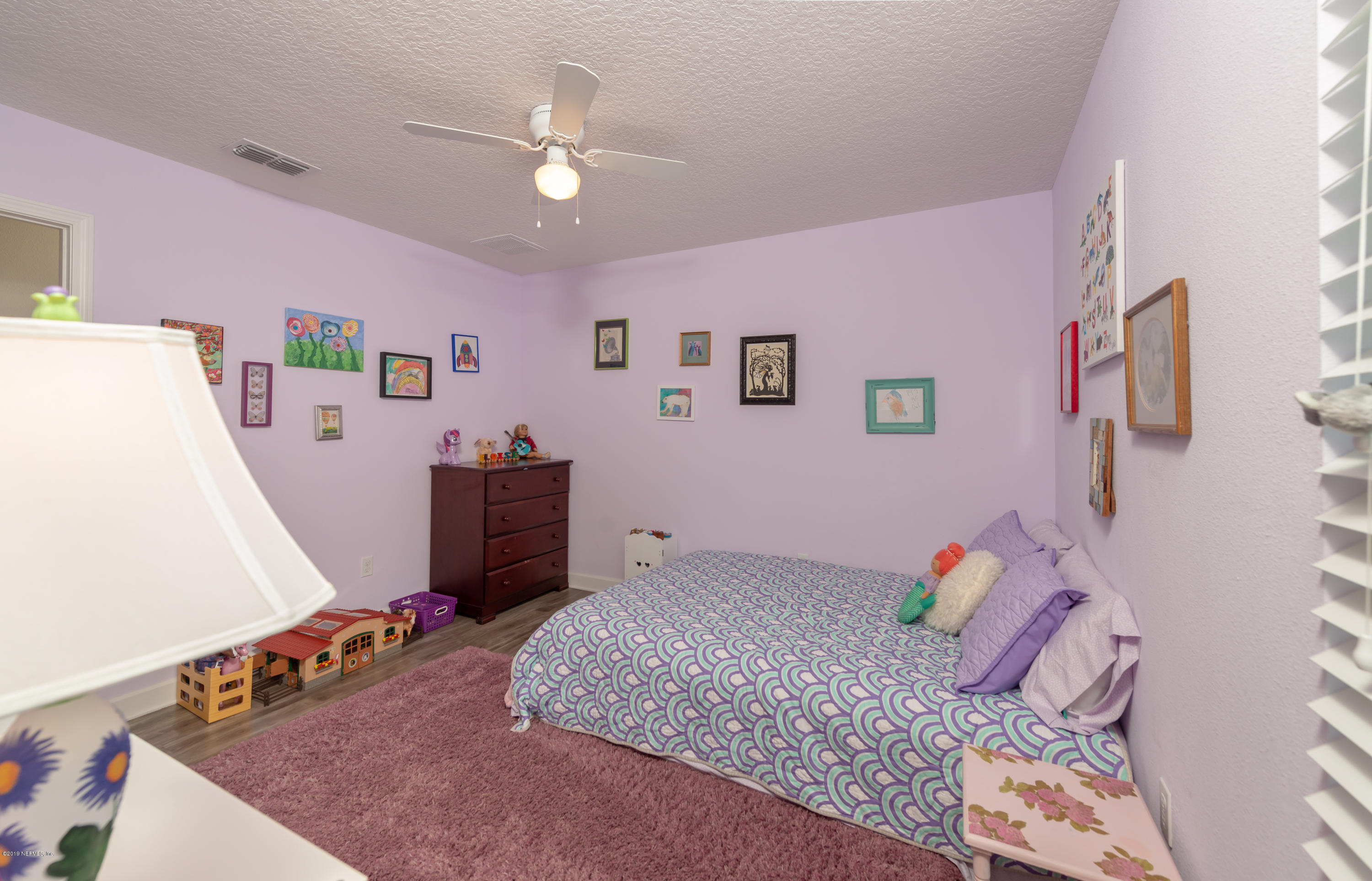 824 Queen Road St. Augustine, FL 32086 - Photo 29 of 35 a bedroom with a bed and a dresser in it