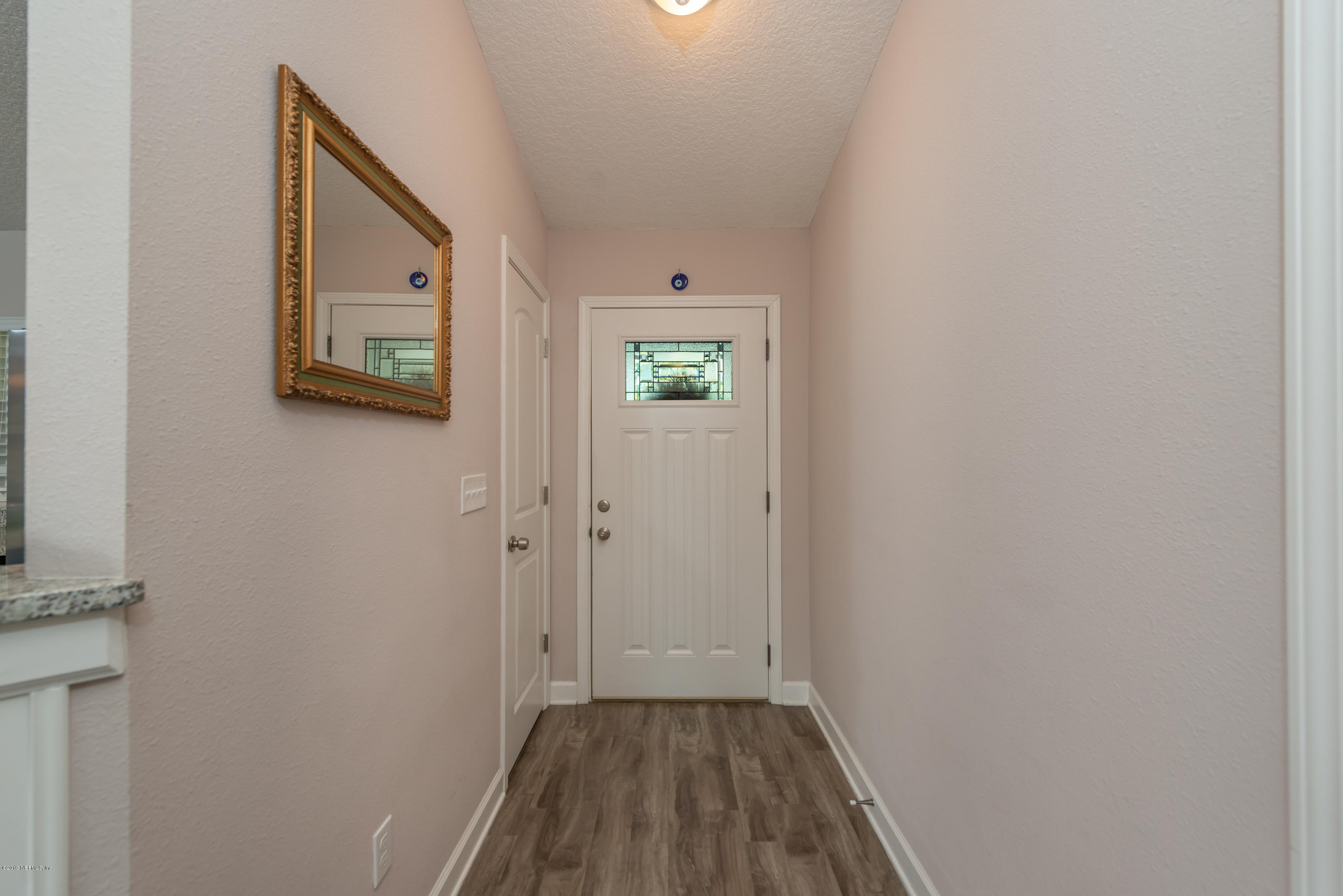 824 Queen Road St. Augustine, FL 32086 - Photo 4 of 35 a view of a hallway with wooden floor and closet