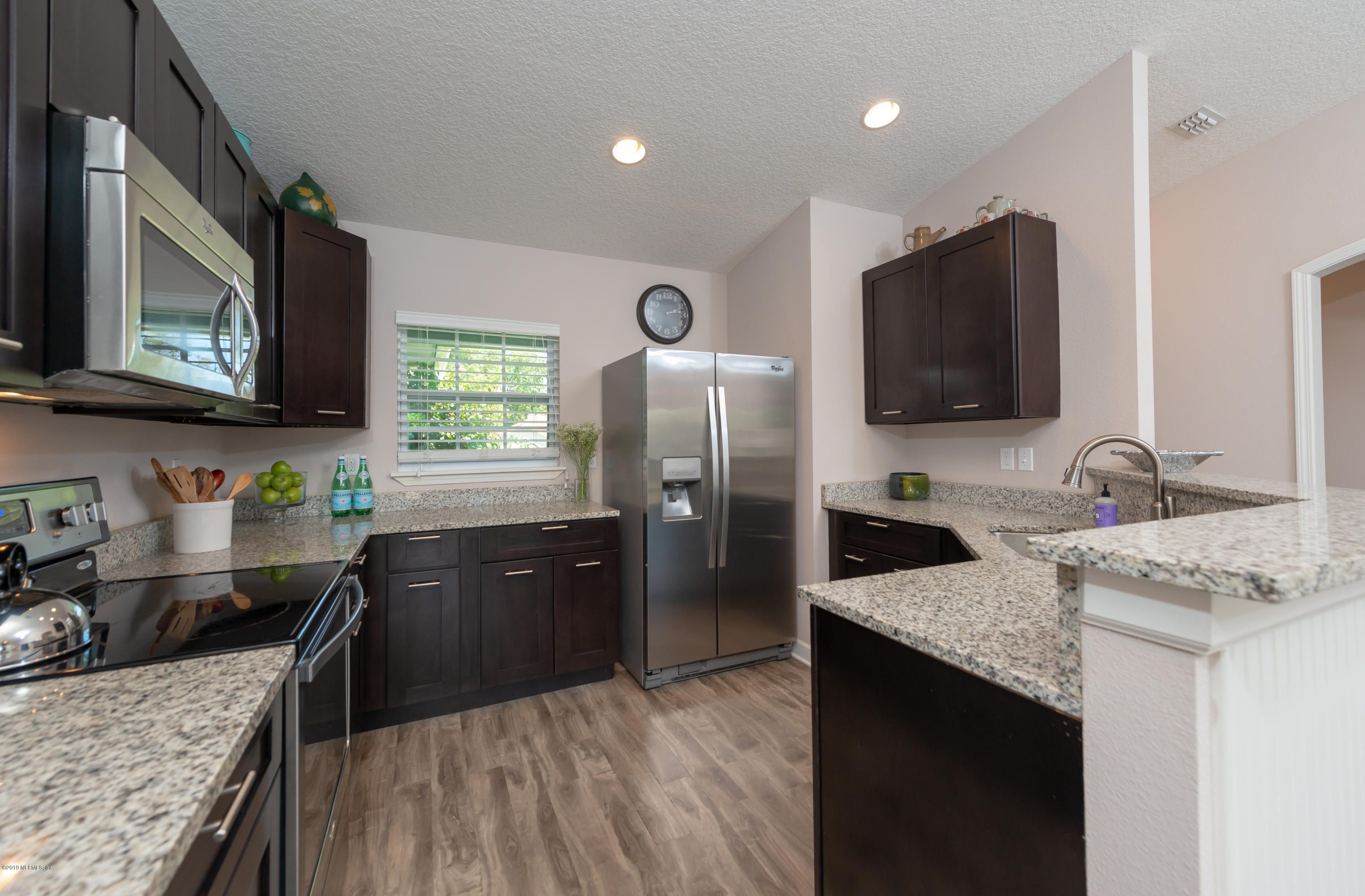 824 Queen Road St. Augustine, FL 32086 - Photo 5 of 35 a kitchen with granite countertop a sink stove and refrigerator