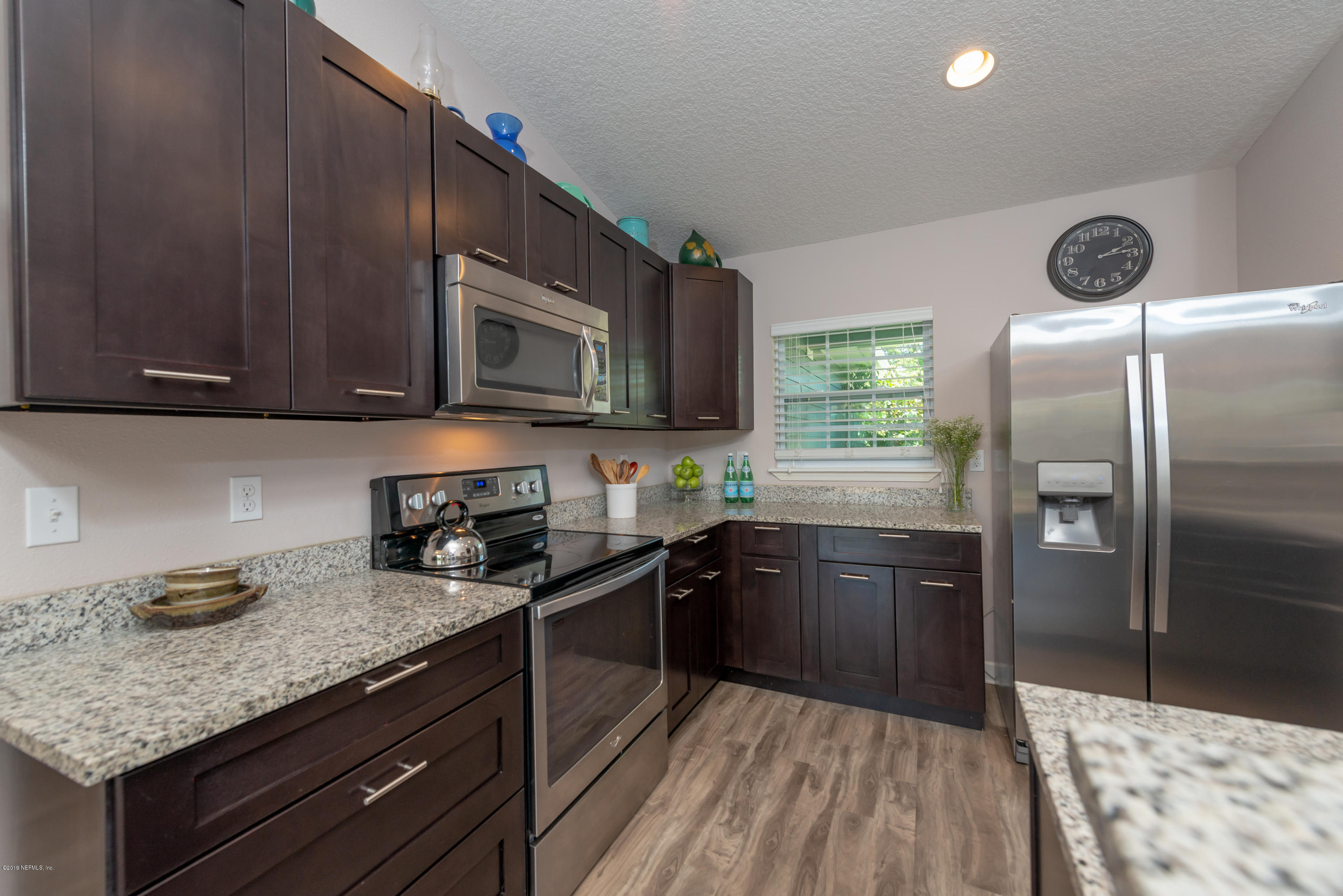 824 Queen Road St. Augustine, FL 32086 - Photo 6 of 35 a kitchen with stainless steel appliances granite countertop a stove a sink dishwasher and a refrigerator with wooden cabinets