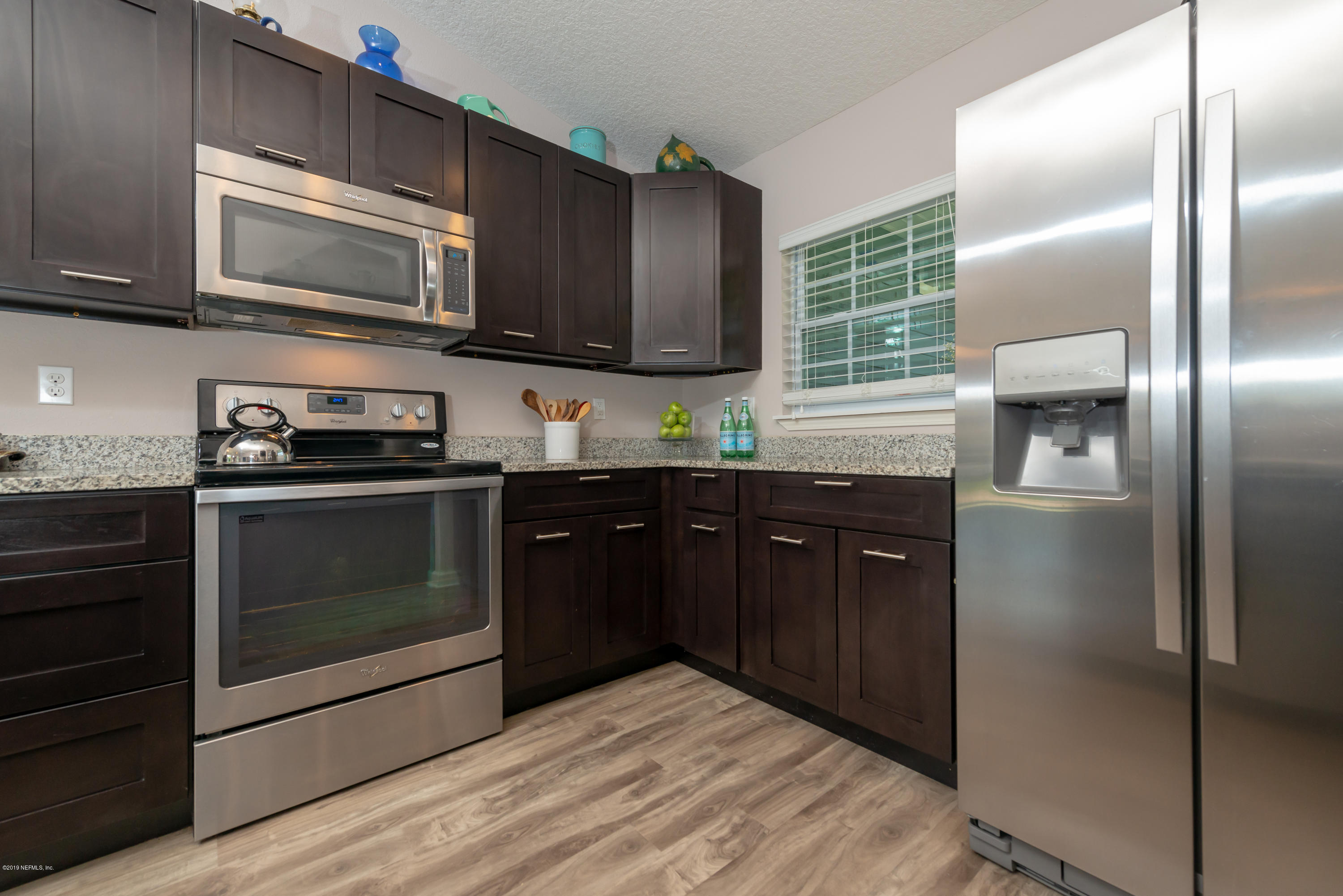 824 Queen Road St. Augustine, FL 32086 - Photo 8 of 35 a kitchen with stainless steel appliances granite countertop a stove microwave and refrigerator