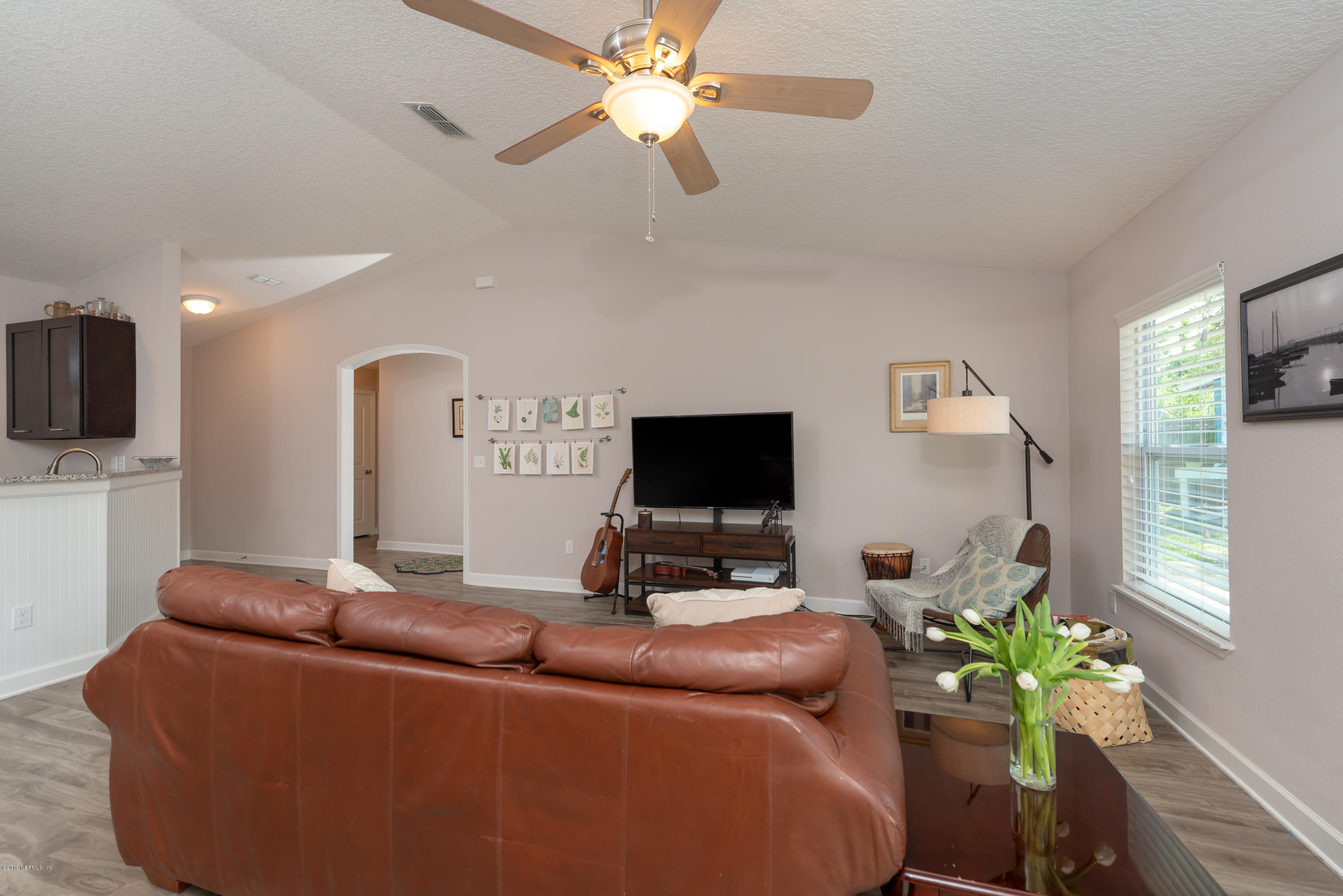 824 Queen Road St. Augustine, FL 32086 - Photo 10 of 35 a living room with furniture a flat screen tv and a fireplace
