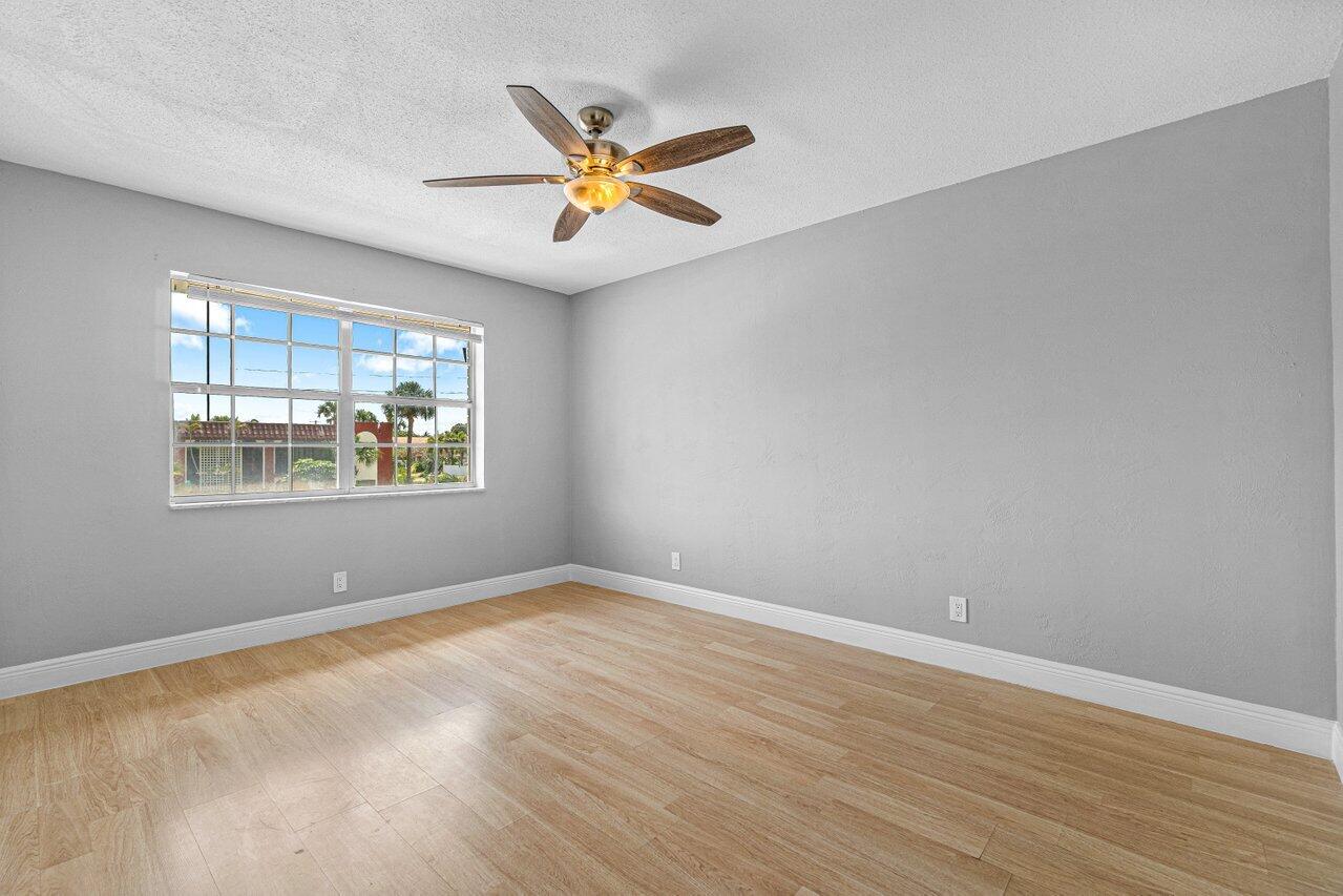 299 Southwest 7th Street, Unit 2060 Boca Raton, FL 33432 - Photo 15 of 20 a view of a big room with wooden floor and windows